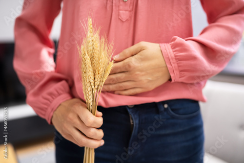 Celiac Disease And Gluten Intolerance. Women Holding Spikelet