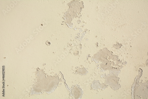 White grey old wall with shabby damaged plaster Cement and brick background of an vintage dirty exfoliating plaster Textured background peeling of colour wallpaper cement