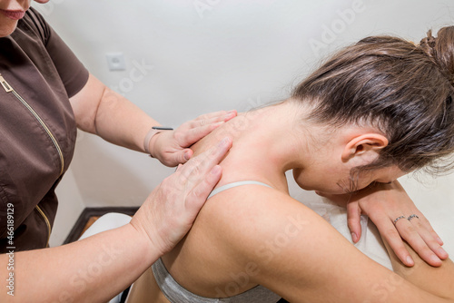 Woman masseuse doing back massage