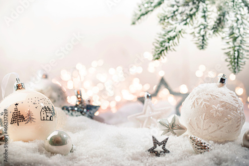 Christmas white decorations on snow with fir tree branches and christmas lights. Winter Decoration Background