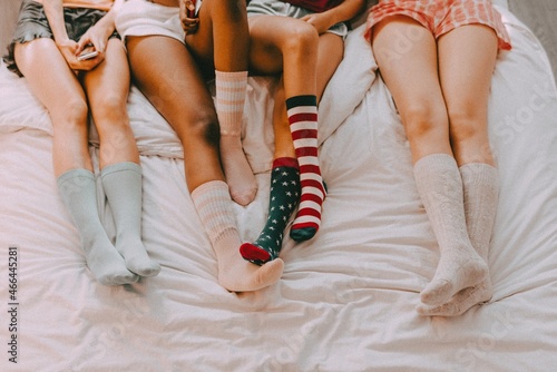Teenage sleepover party aesthetic, girls wearing colorful socks