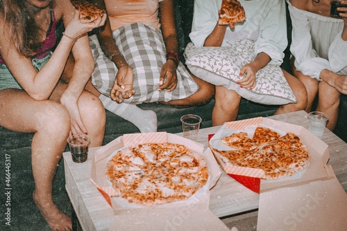 Friends eating pizza, hanging out at a sleepover party