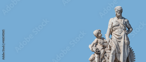 Banner with sculpture of old engineer and his scholar on Custom Bridge in Magdeburg downtown, Germany, at blue sky solid background with copy space. Concept of historical architecture heritage.