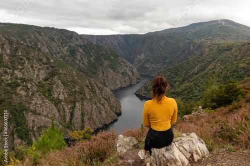 Impressive viewpoint of the Sil Canyon(Canon do Sil) in the Ribeira Sacra, with a girl in a yellow sweater in the foreground, in Galicia