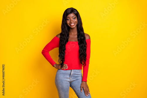 Photo of pretty sweet dark skin girl dressed red top arm waist standing isolated yellow color background