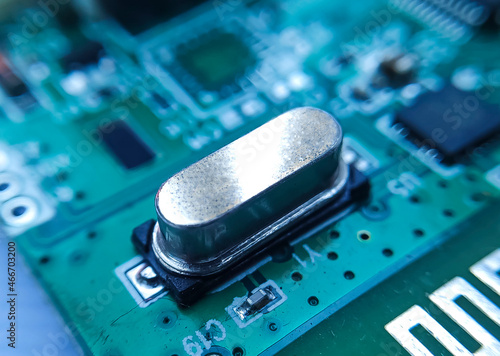 Close up image of crystal oscillator or electronic oscillator circuit. Electronic component.