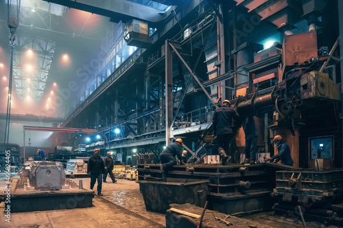 Heavy industry, steel mill foundry industrial metallurgical plant workshop interior, steelmaking manufacturing with many workers.