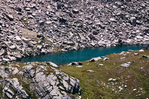 Narrow pond surrounded by rocks in Gran Paradiso Natural Park in Italy