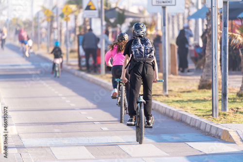 young people riding a bicycle on a bikeway in La Serena