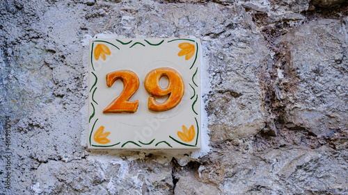 Ceramic house number on wall. number twenty-nine. 29