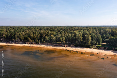 aerial sea side view of the Baltic Sea coast with a sandy beach and red sandstone cliffs