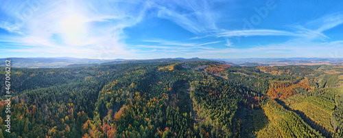 Mountains covered with autumn colored forest, aerial view. Beautiful nature landscape panorama