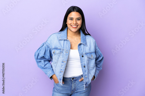 Young latin woman woman over isolated background laughing