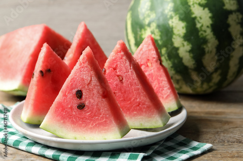 Delicious fresh watermelon slices on wooden table, closeup