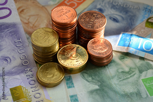 Close-up shot of Swedish krona bronze and golden coins on banknotes