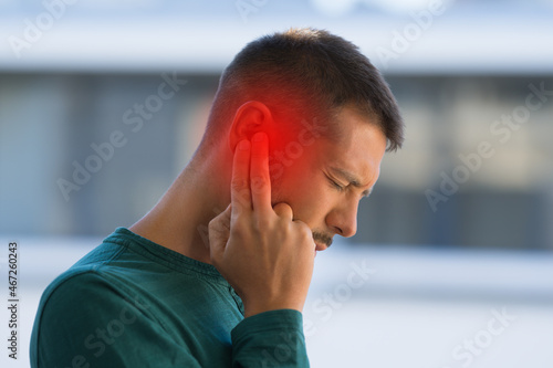 Man suffering because of strong earache or ear pain. Otitis