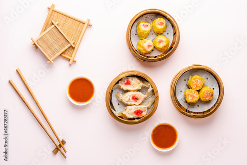 Top View of Assorted Chinese Dimsum in bamboo basket. Dimsum is a large range of small dishes that Cantonese people traditionally enjoy in restaurants for breakfast and lunch.