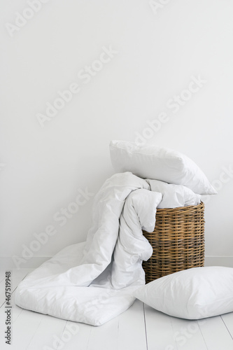 Clean bed linen in a wicker basket