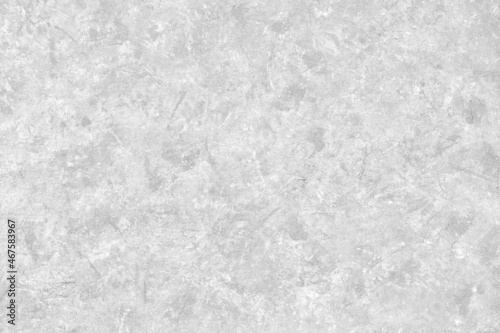 Abstract light grey plastered textured grunge background in the form of a rough covered stucco wall, closeup