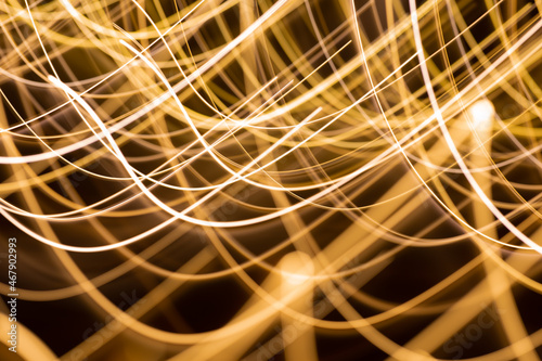 illumination and backgrounds concept - golden electric light effect lines on dark background