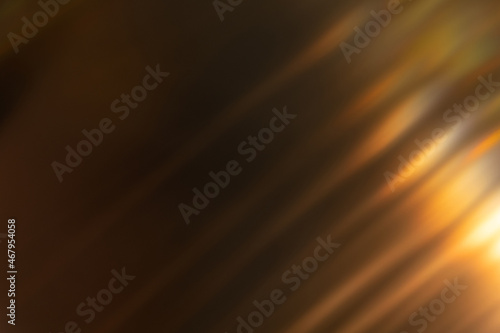 Blur light overlay. Lens flare rays. Defocused glare. Old film flash leak. Bokeh golden orange color beam design glow on dark black abstract background.