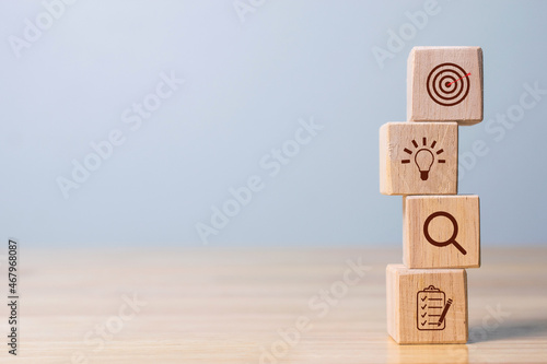 Wood cube block stacking with icon. business strategy and action plan Concept.