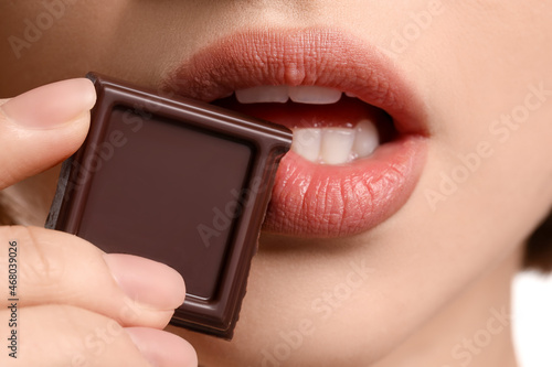 Beautiful young woman with sweet chocolate, closeup