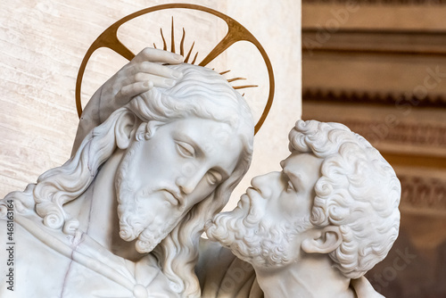 Close-up on faces of marble religious statues portraiting Judas kissing Jesus´s cheek