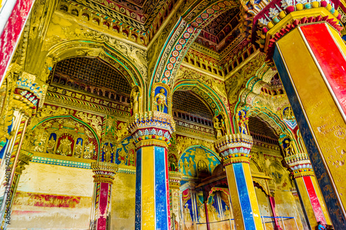 Thanjavur, Tamil Nadu, India - The high arches artworks and colorfully painted wall murals and ceilings of the ancient 17th-century durbar hall Maratha Palace in the town of Thanjavur