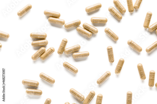 Vitamin K pills scattered on white background