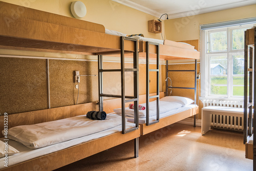 Cosy and quiet room with bunk beds and walls covered with warm colours and ecological environment and recycled materials.Family room. Shared hostel room. Nordic atmosphere and decoration.