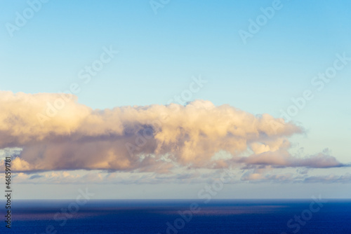 Trade Winds clouds reflected on the ocean at sunset. The trade winds or easterlies are the permanent east-to-west prevailing winds that flow in the Earth equatorial region