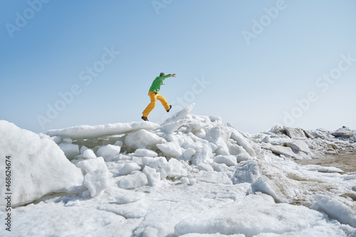 Young adult man outdoors exploring icy landscape