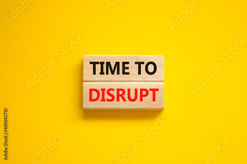 Time to disrupt symbol. Concept words Time to disrupt on wooden blocks on a beautiful yellow background. Business and time to disrupt concept. Copy space.