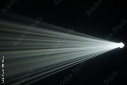 Light beam from spotlight or projector texture and black background and copy space - backdrop image