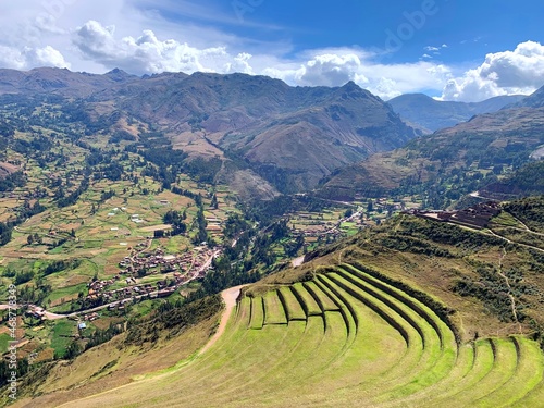 Terraced fields of Incas in Sacred Valley Urubamba in Peru among Andes mountains in summer sunny day. Beautiful view on ancient green grass terraces Urubamba valley Pisac region in Peru.