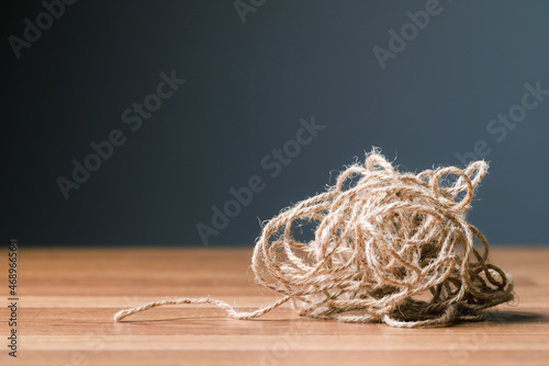 Tangled jute rope on the table, concept for complicated or complex issue