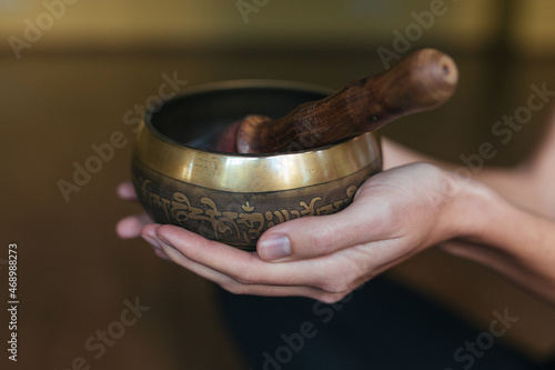 Close-up hands of a woman playing on singing bowls. Relaxation and meditation. Tibetan singing bowls. 