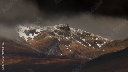 First snow on the slopes of Ben Lawers in cloudy weather.