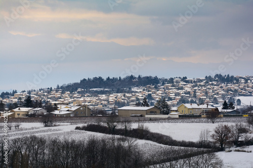 Snowed landscape and village of Beaujolais, France