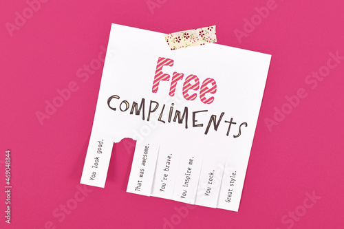 Tear off note with motivational free compliments on pink background