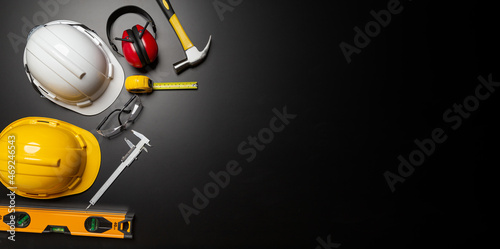 Work safety. Construction site protective equipment on wooden background, flat lay, copy space, top view