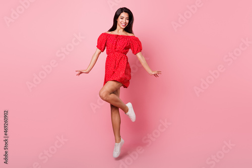 Full body photo of sweet millennial lady jump wear red dress isolated on pastel pink color background