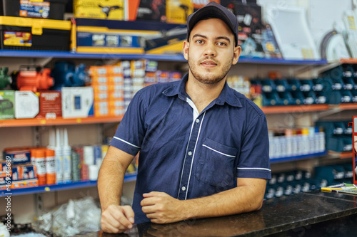 Young latin man working in hardware store