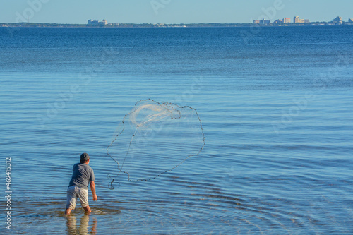 A Fisherman throwing His cast net to get bait fish. On Hammock Bay in Freeport, Walton County, Florida