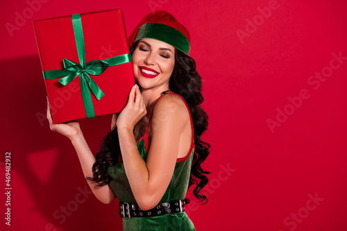 Photo of dreamy lusty lady close eyes receive intimate gift wear elf hat costume isolated red color background