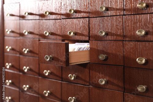 Open wooden drawer with index cards of library catalog