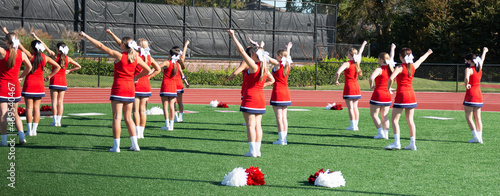 High school cheerleading squad practicing before homecoming