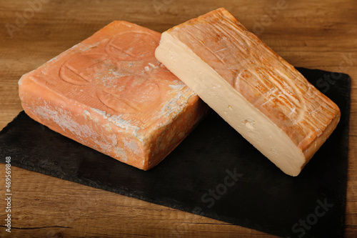 Taleggio cheese on rustic background