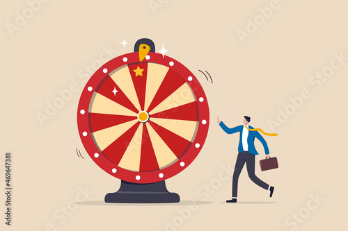 Life depend on luck, fortune wheel randomness, chance and opportunity to get new job, investment winning or gambling concept, excite businessman looking at spinning fortune wheel waiting for luck.